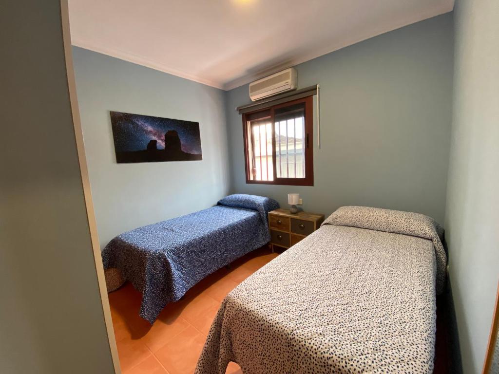 Postel nebo postele na pokoji v ubytování Villa Mogan Mall, con jacuzzi y PlayStation 5