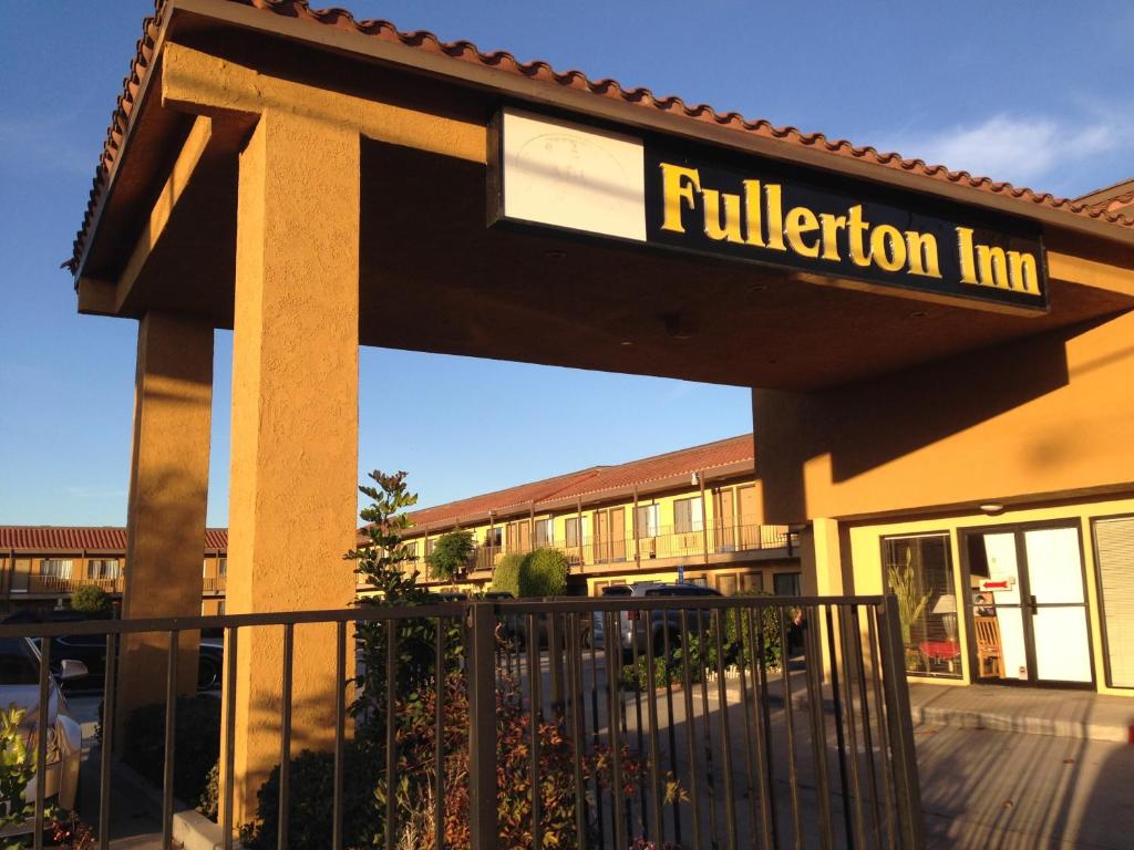a building with a sign for a fusion inn at Fullerton Inn in Fullerton