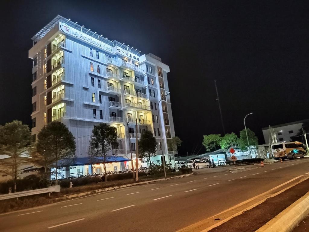 a tall building on the side of a street at night at The One Boutique Hotel in Sekinchan