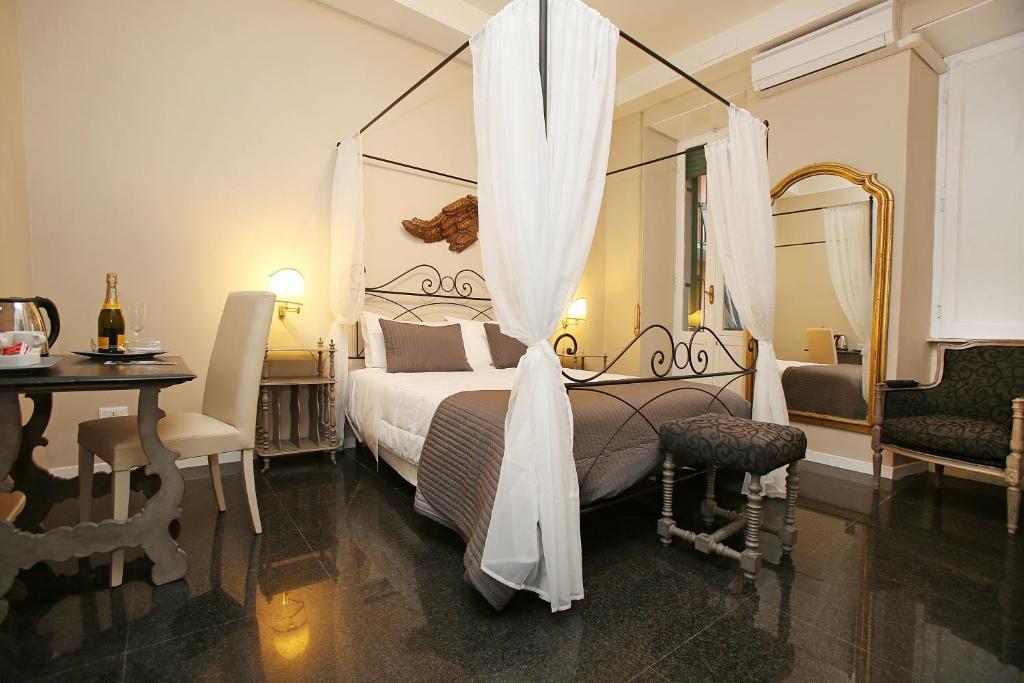 ローマにあるAmica Roma Guest Houseのベッドルーム(ベッド1台、テーブル、鏡付)