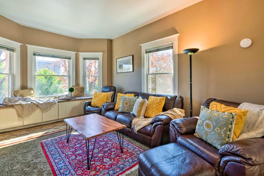 a living room with leather couches and a table at Salt Lake City Condo Less Than 28 Mi to Ski Resort! in Salt Lake City