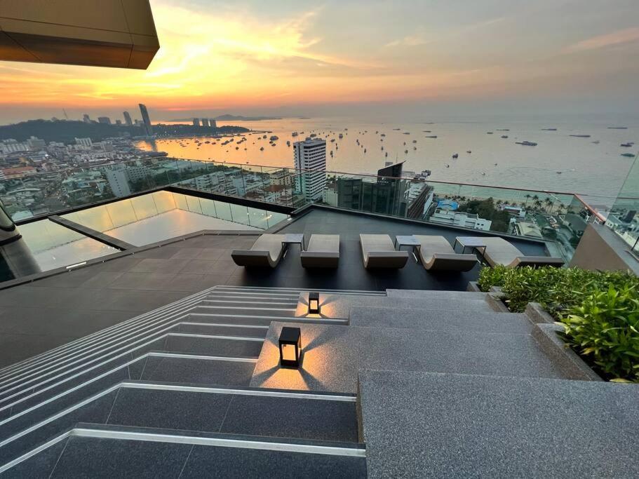 a building with benches and a view of the ocean at Secret Gem Sea-View King Size EDGE Central Pattaya in Pattaya Central