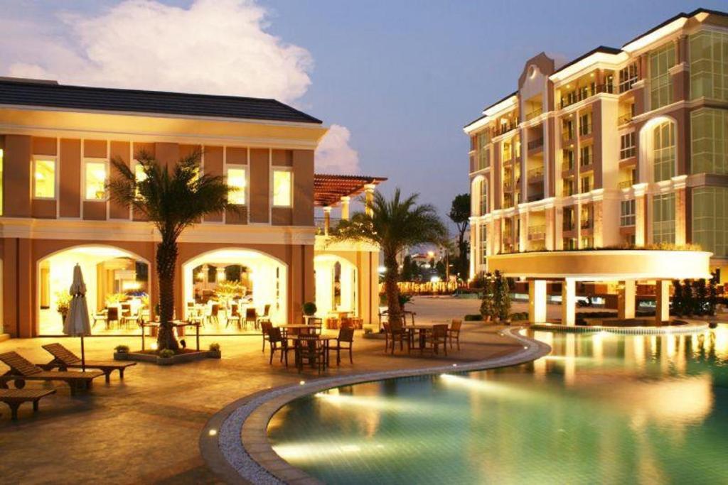 a resort with a swimming pool in front of buildings at LK Legend in Pattaya Central