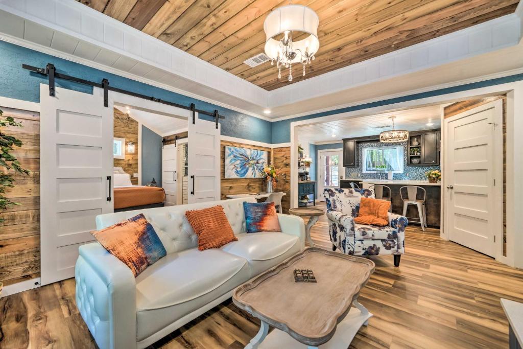 a living room with a white couch and chairs at Modern Broken Bow Cabin, Near Lake and Wineries in Broken Bow