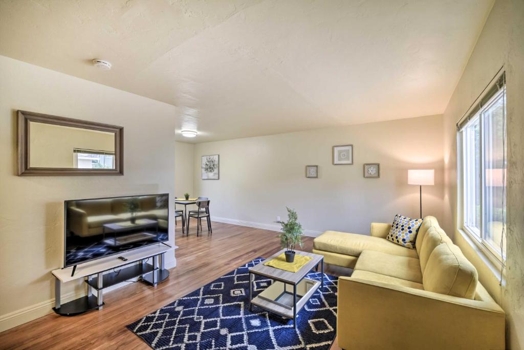 a living room with a couch and a flat screen tv at Cozy Mountain View Apt Near Downtown San Jose in Mountain View