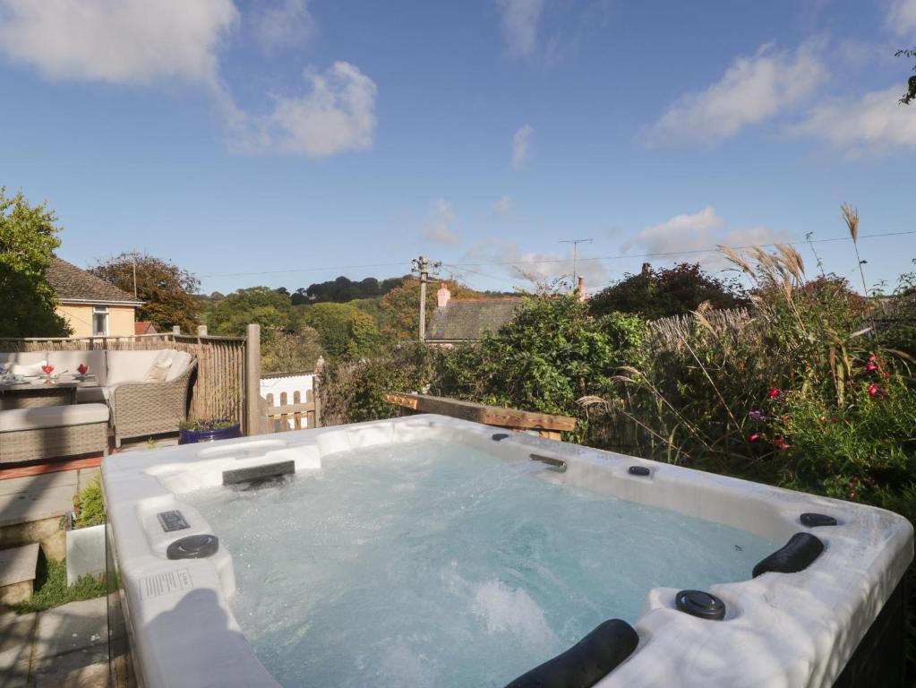 a large swimming pool in a backyard with at Pound Cottage in Lyme Regis