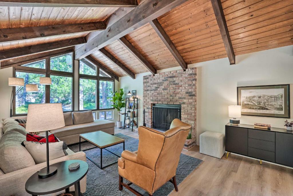 a living room with wooden ceilings and a fireplace at Near Hiking and Yuba River Nevada City Retreat! in Nevada City