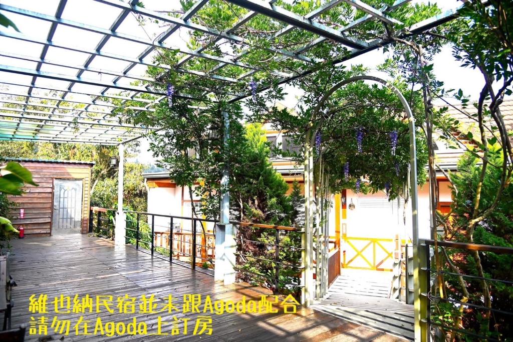 an entrance to a garden with a pergola at Cingjing Vienna Pleasance Cottage in Ren&#39;ai