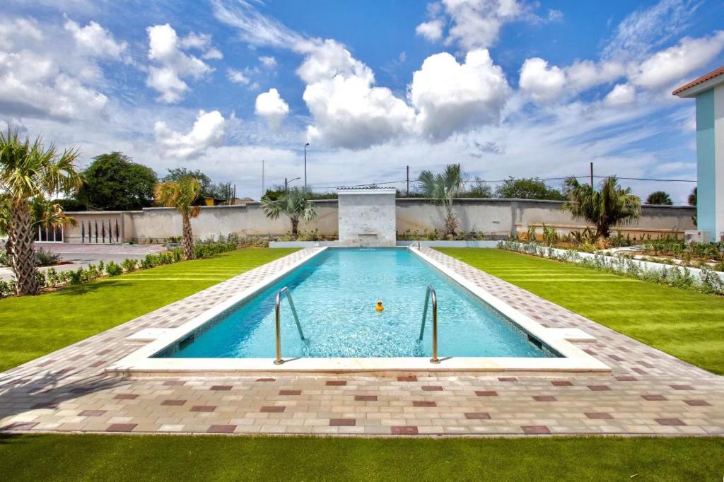 a swimming pool in the middle of a yard at Penthouse Apartment next to Blue Bay Golf & Beach! in Willemstad