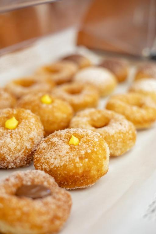 a bunch of donuts with sprinkles on a table at Hotel Sabbia d'Oro in San Vito lo Capo