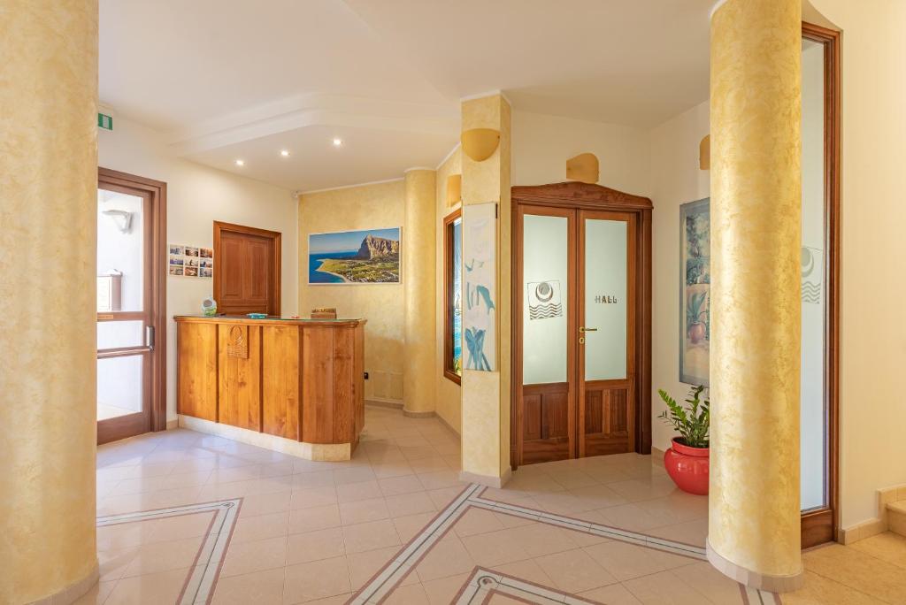 a large room with a column in a building at Hotel Sabbia d'Oro in San Vito lo Capo