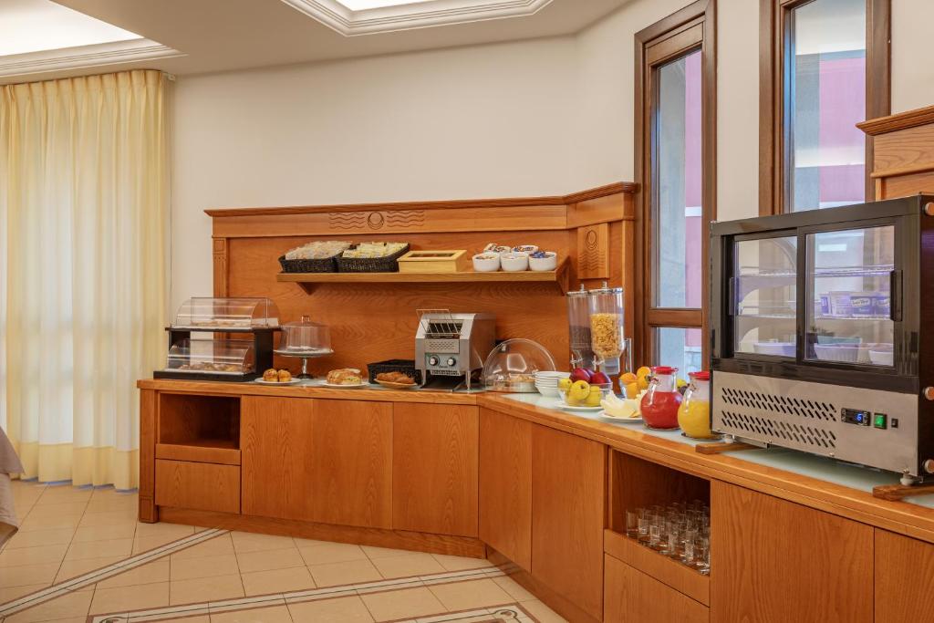 a kitchen with a counter with a counter top at Hotel Sabbia d'Oro in San Vito lo Capo