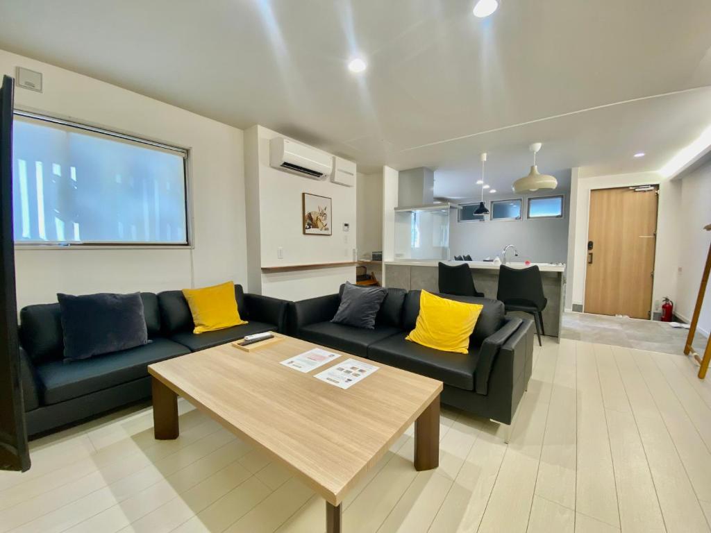 a living room with a couch and a table at Villa Monica in Nagoya