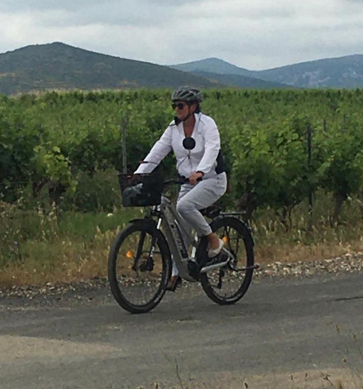 a man is riding a bike on a road at Gites Còr Causy OLEANDER in Causses-et-Veyran