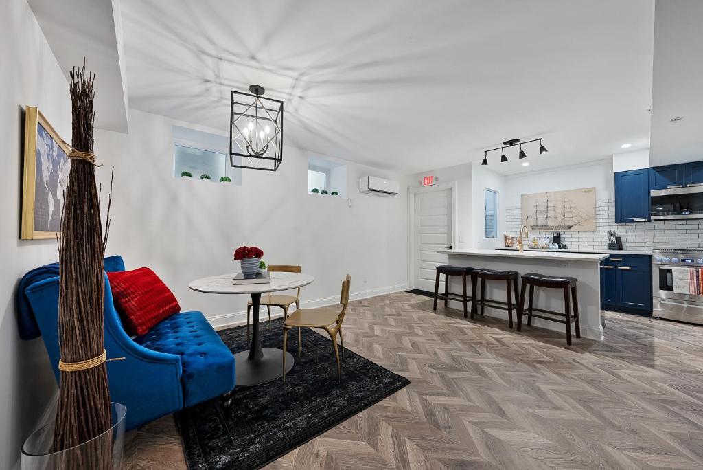 a living room with a blue couch and a table at Beautiful Condo Steps from Shoreline Park - A in Sandusky