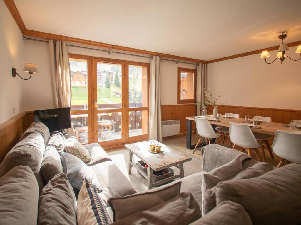 a living room with a couch and a table at Appartement Valmorel, 4 pièces, 6 personnes - FR-1-291-791 in Valmorel