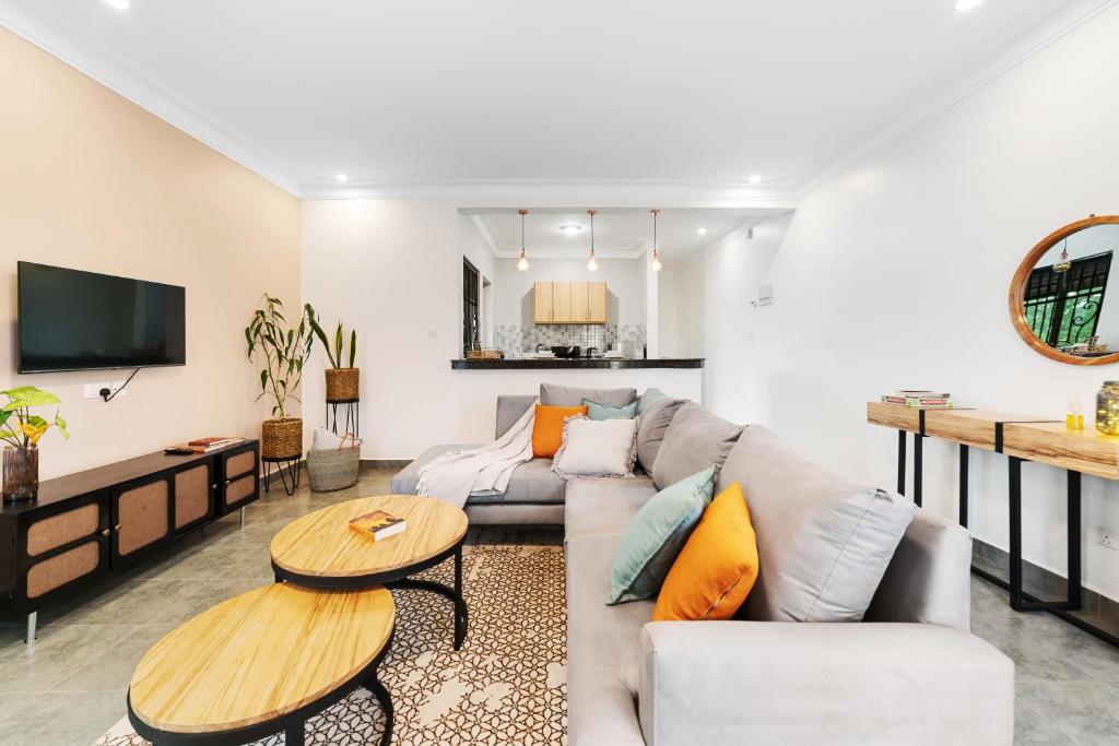 a living room with a couch and a table at Polo Apartments in Kampala