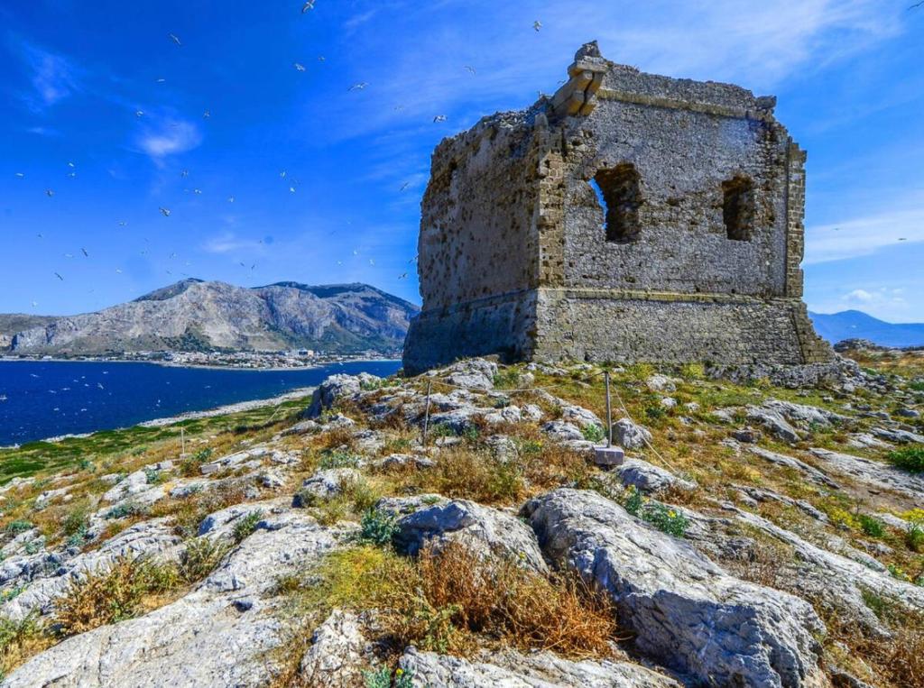 an old building on the side of a mountain at AR Palace Hotel - Palermo in Isola delle Femmine