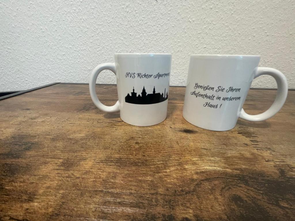 two coffee mugs sitting on top of a table at Richter Apartments 3 in Finsterwalde