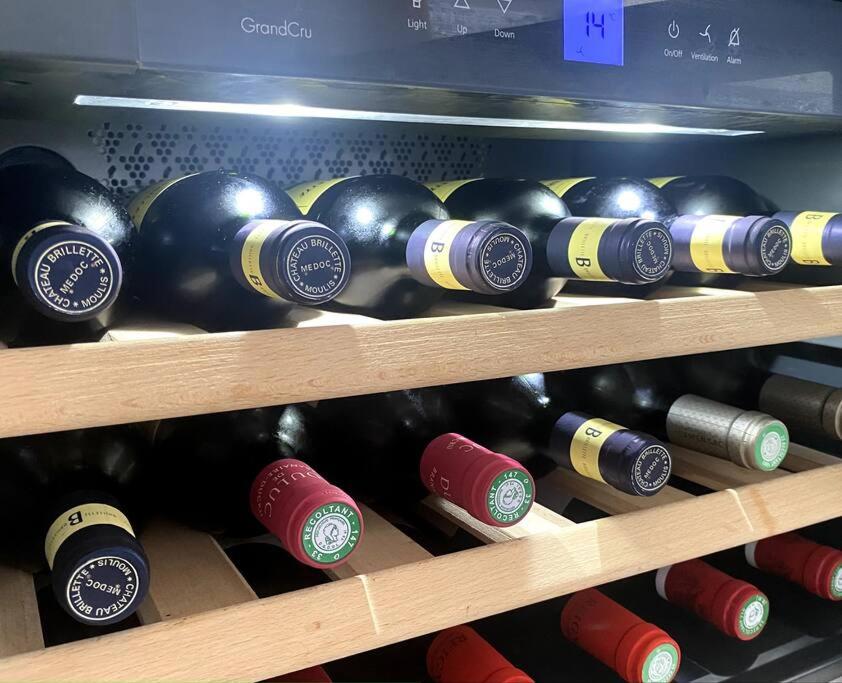 a bunch of wine bottles on a shelf at Villa Anse Vinaigri - Plage à pieds in Le Gosier