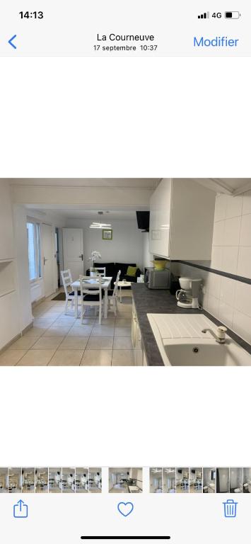 une cuisine avec une table et une salle à manger dans l'établissement Gite Mella, à La Courneuve