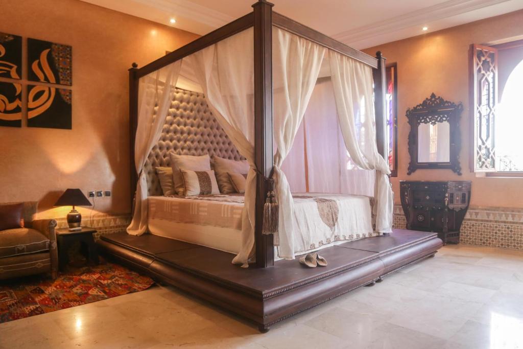 a bedroom with a canopy bed in a room at Villa Taj Sofia & Spa in Marrakesh