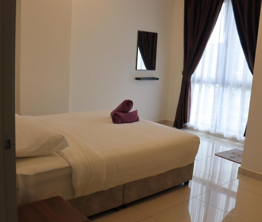 Postel nebo postele na pokoji v ubytování ATS Cameron Hotel & Apartments