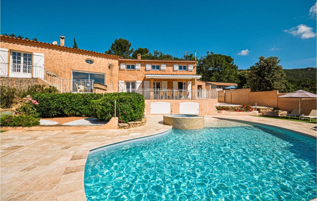 a large swimming pool in front of a house at Amazing Home In Ste-anastasie-s-issole With Jacuzzi, Wifi And Private Swimming Pool in Sainte-Anastasie-sur-Issole