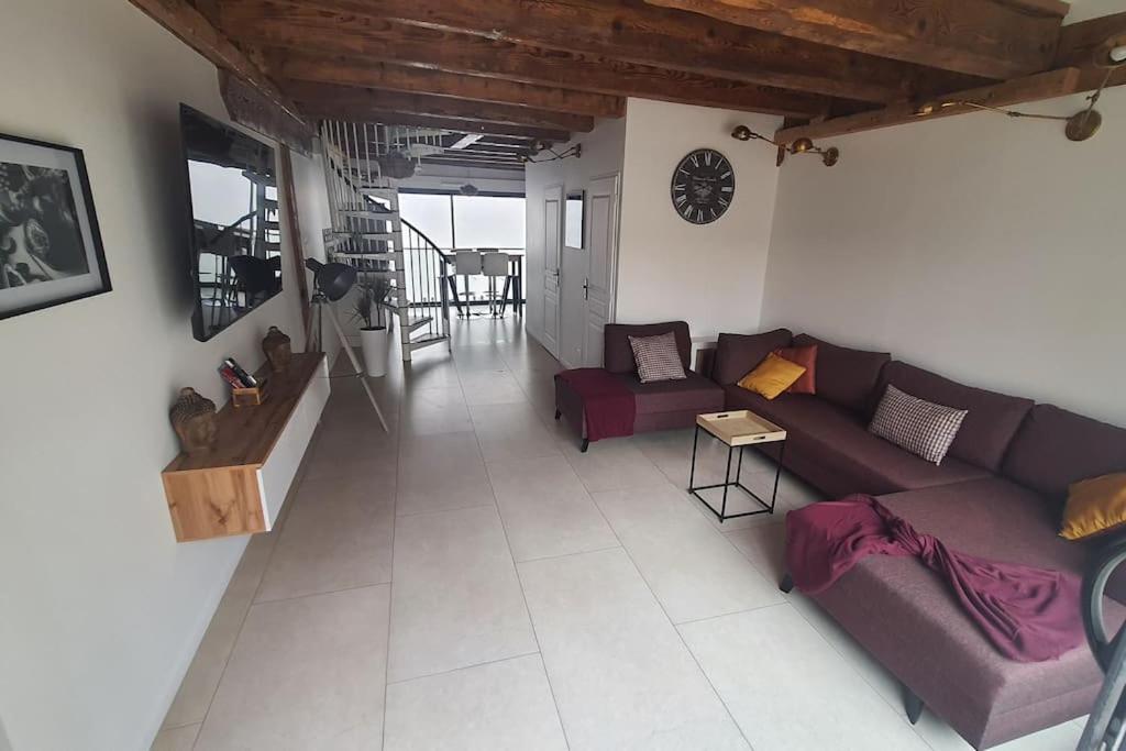 a living room with a couch and a table at Beau T3 au cœur du centre ville in Narbonne