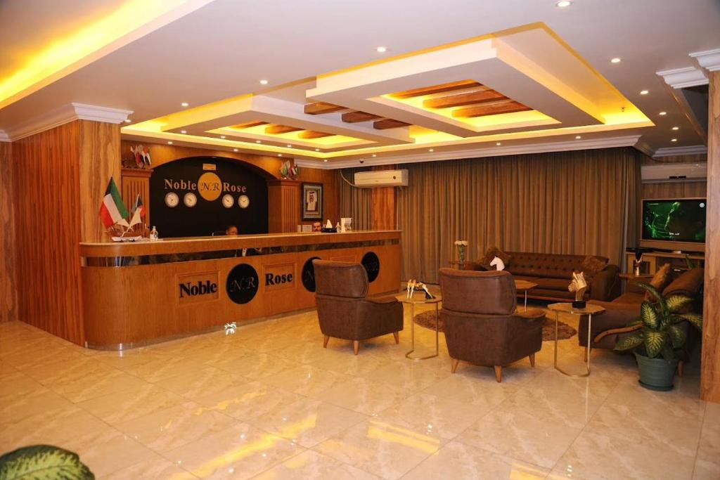 a lobby of a hotel with chairs and a bar at Noble Rose Apartment in Kuwait