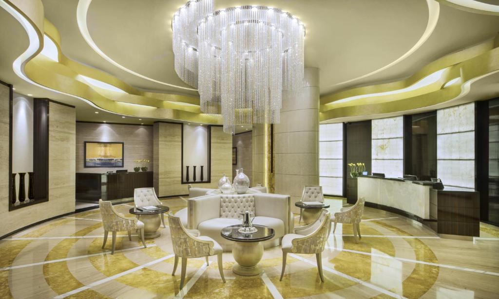 a large room with a large clock on the ceiling at DAMAC Maison Cour Jardin in Dubai