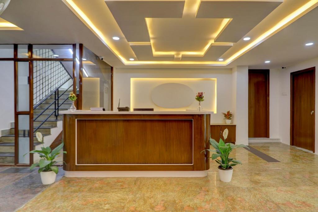 a large lobby with a podium and stairs at Destino By INR Suites in Hyderabad
