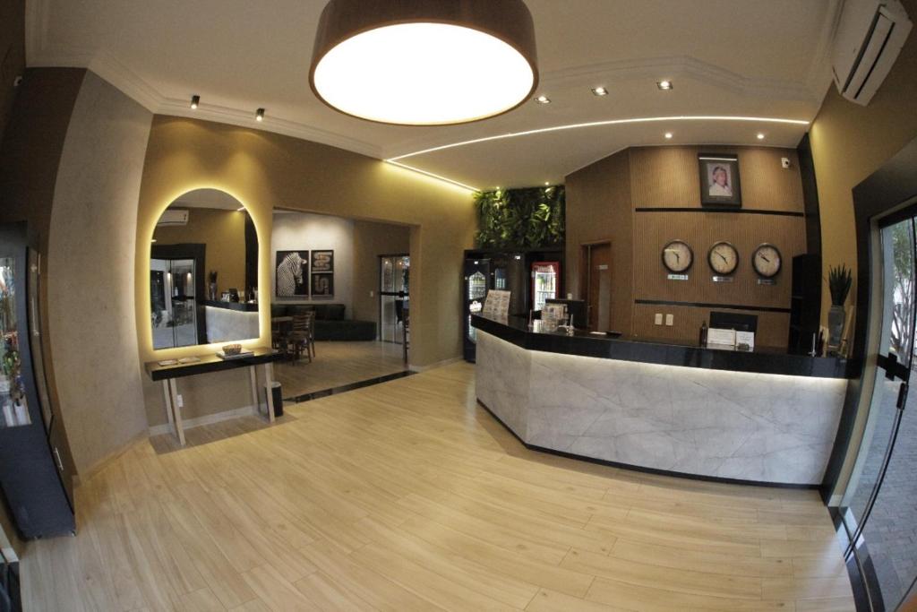 a lobby with a reception desk in a building at Savana Park Hotel in Andradina