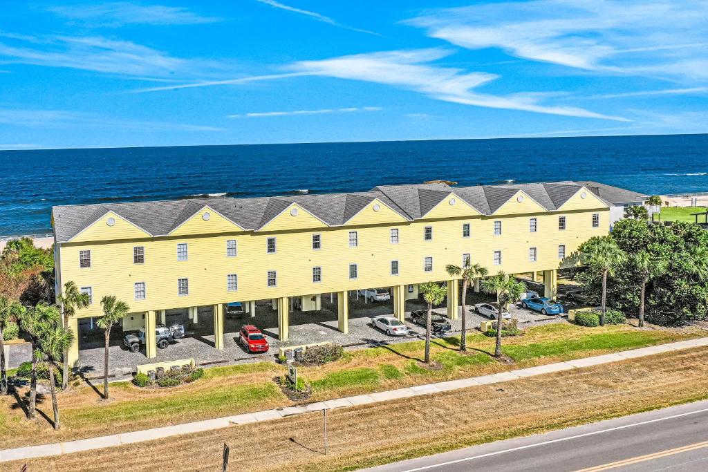 an aerial view of a building with the ocean in the background at Ocean Vue in New Smyrna Beach