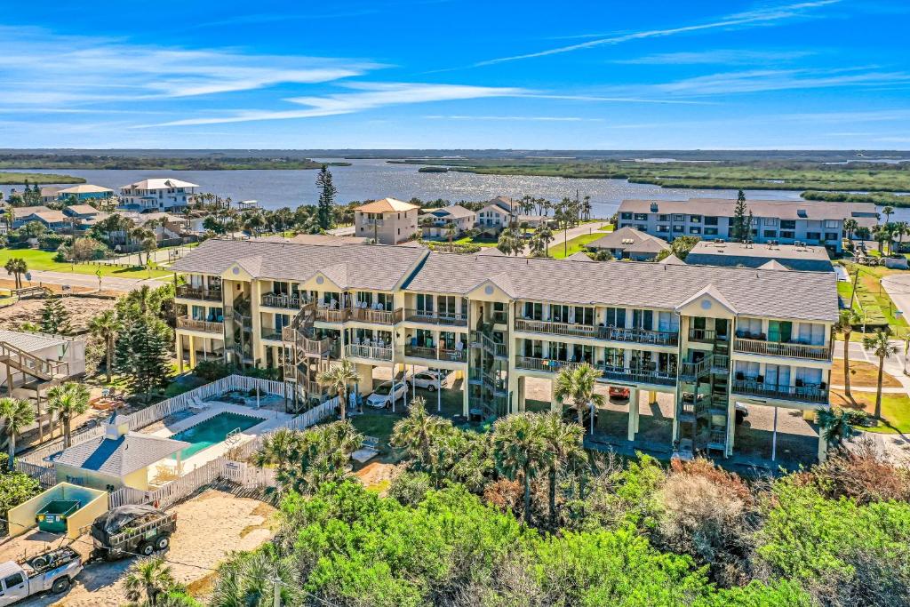 an aerial view of a large building with a swimming pool at Ocean Vue in New Smyrna Beach
