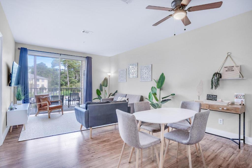 a living room with a table and chairs at Pointe of View 407- Penn's Paradise in Destin