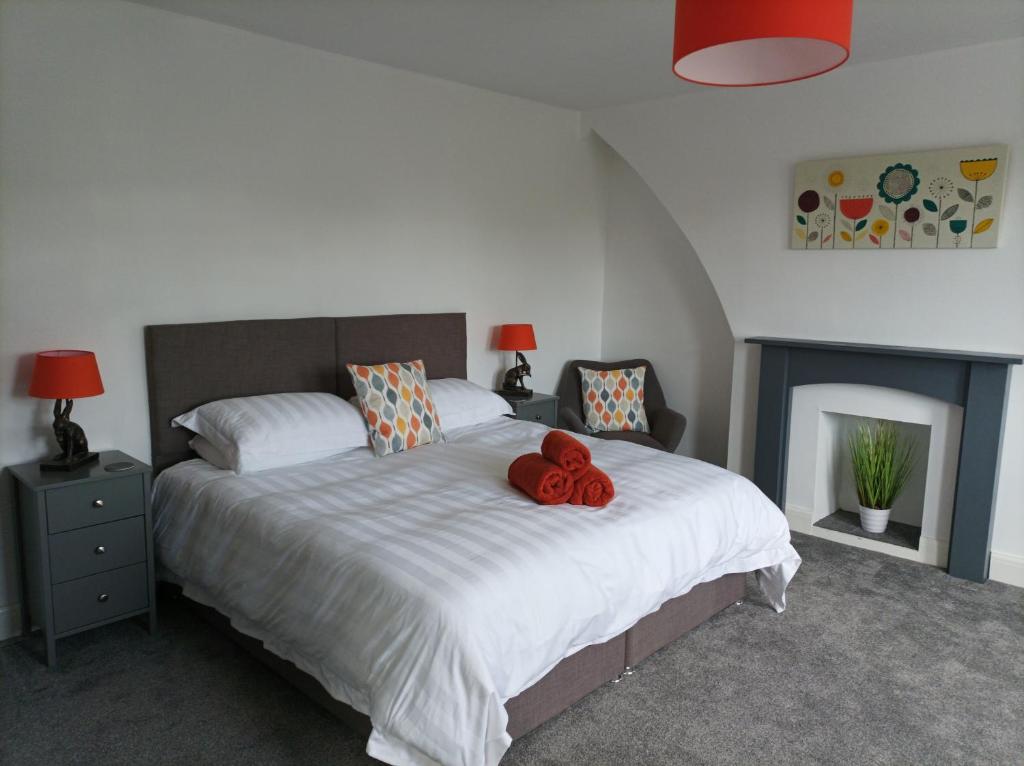 a bedroom with a bed with a red teddy bear on it at Victorian Renovation Room 6 in Liverpool