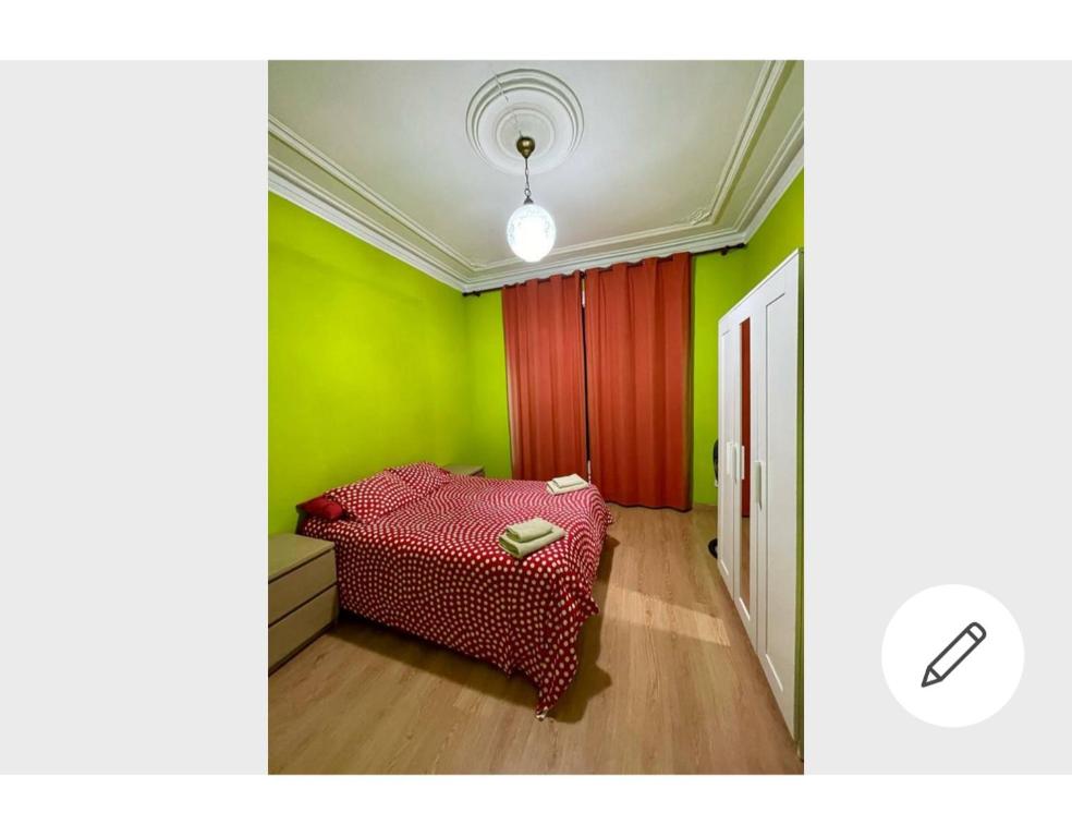 a room with a red bed and green walls at Barcelona Centric in Barcelona