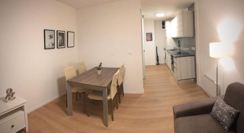 a kitchen and dining room with a table and chairs at Riva Guest House Apartment in Riva del Garda