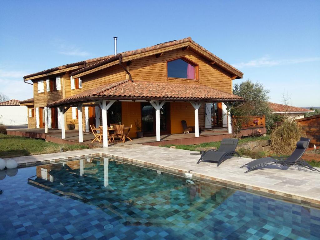 a house with a swimming pool in front of a house at Ecolodge Bellevue ALBI in Albi