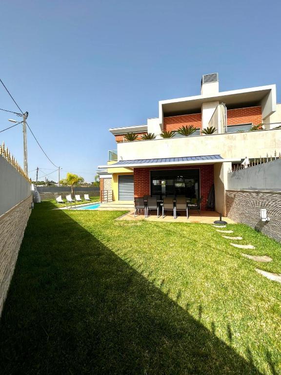 a house with a lawn in front of it at Funtastic Villa With Pool in Albufeira