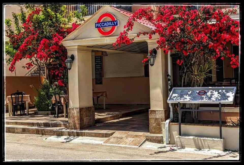 アリケスにあるPiccadillyの赤い花と看板のガソリンスタンド