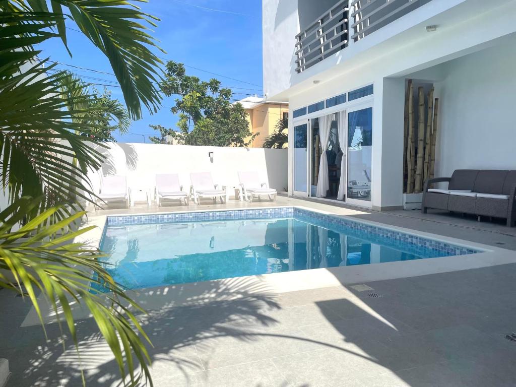 a swimming pool in front of a house at Gaia Residence Deluxe in San Felipe de Puerto Plata