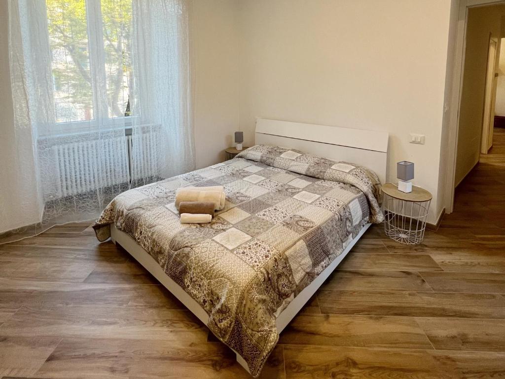 a bedroom with a bed and a large window at Casa D'Aria in Savona