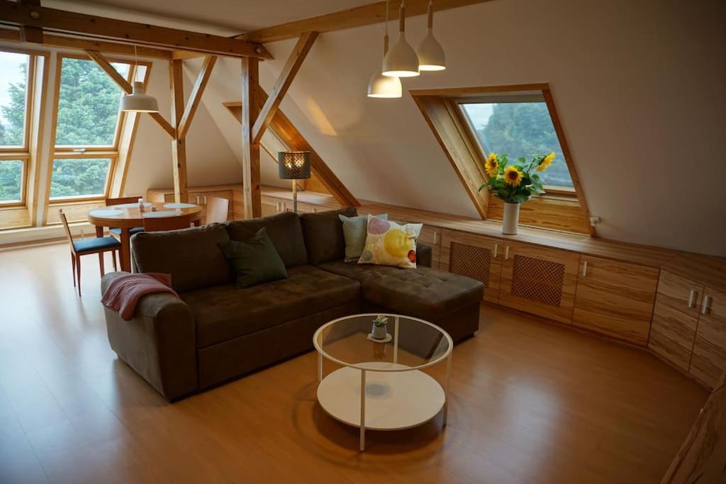 a living room with a couch and a table at Apartment mit Ausblick im Dresdner Südwesten in Dresden