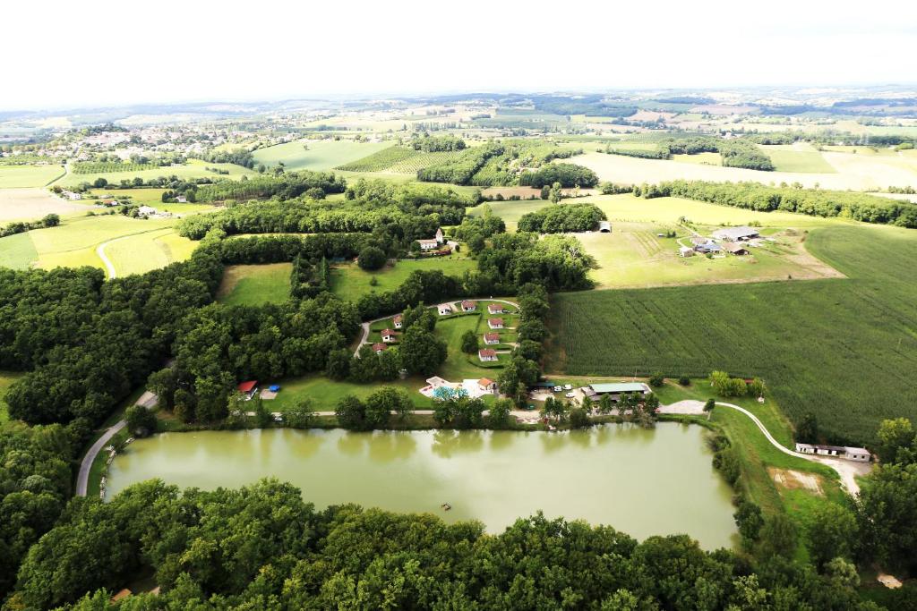 an aerial view of a park with a lake at Lac De Cancon in Cancon