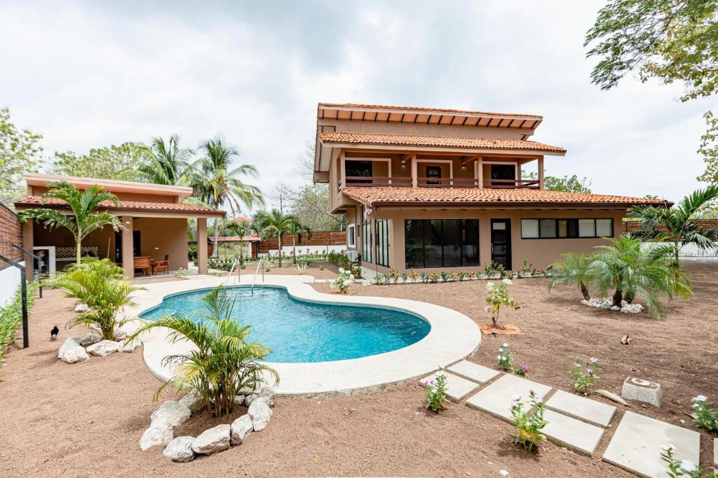 una casa con piscina frente a ella en Flamingo Estates 18- 4 BR House with Pool en Brasilito