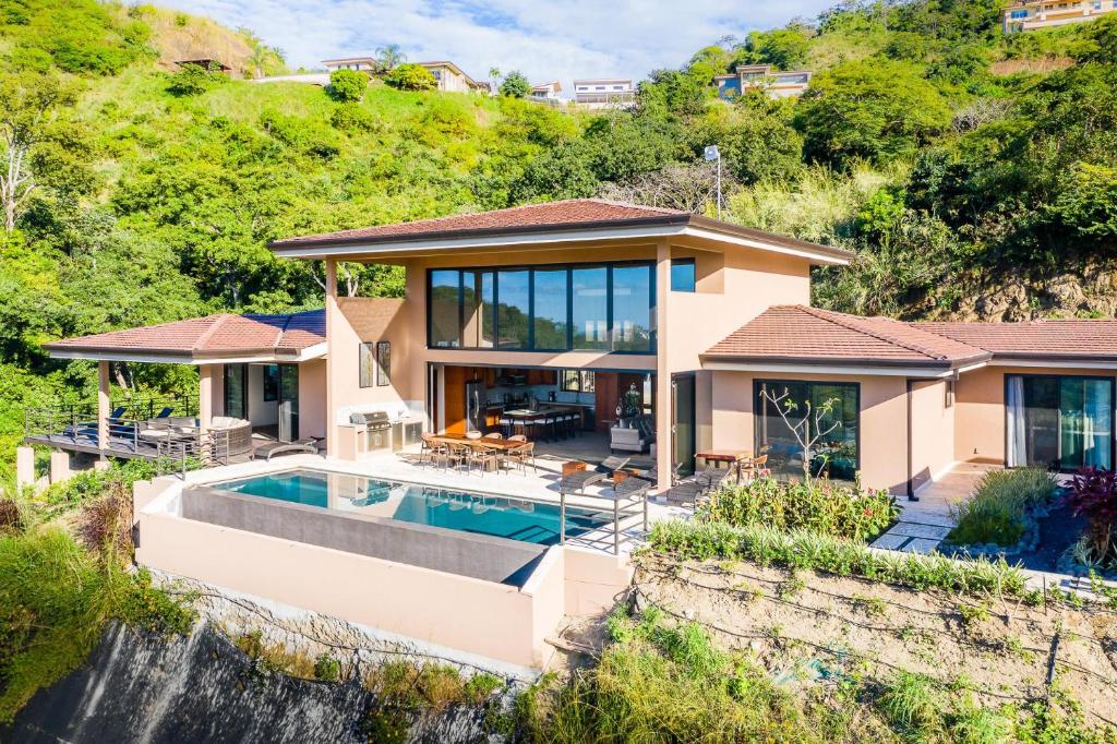 a house with a swimming pool and a waterfall at Casa Vistas At Mar Vista in Brasilito
