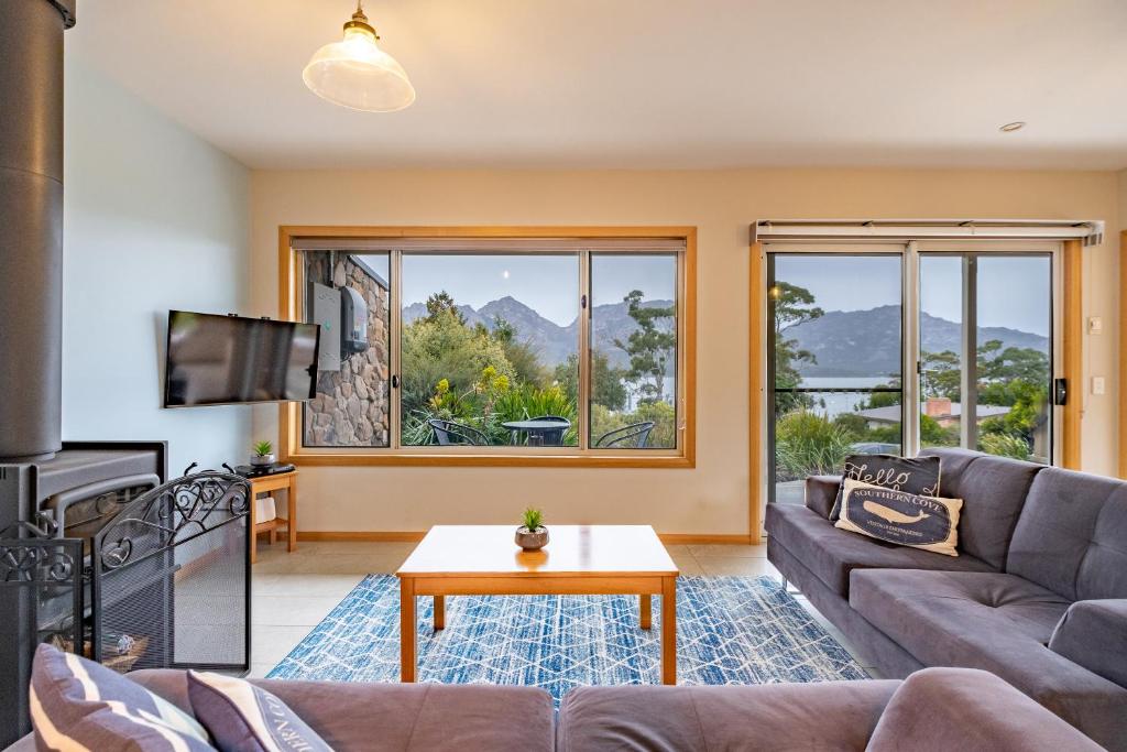 a living room with a couch and a table at Freycinet Stone Studio 5 - Greystone in Coles Bay