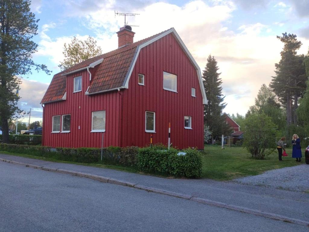 a red barn sitting on the side of a road at Holiday home LJUSDAL III in Ljusdal